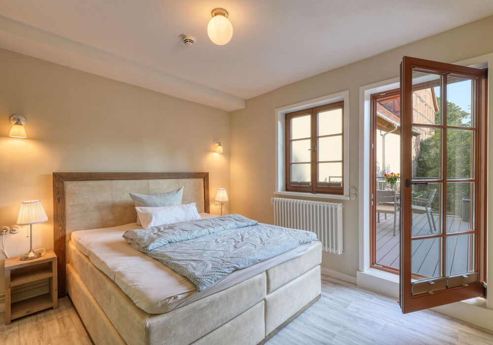box spring bed for 2 people with nightstands in a bright, sunlit bedroom